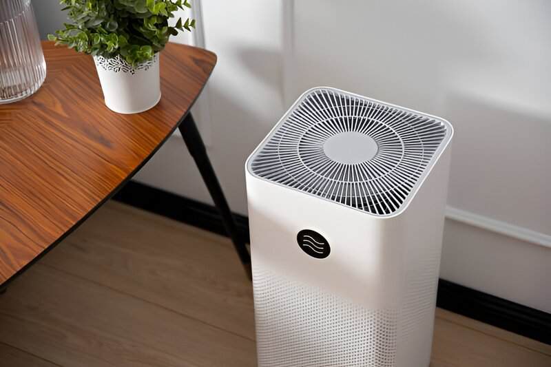 Sleek air purifier stands amidst lush houseplants
