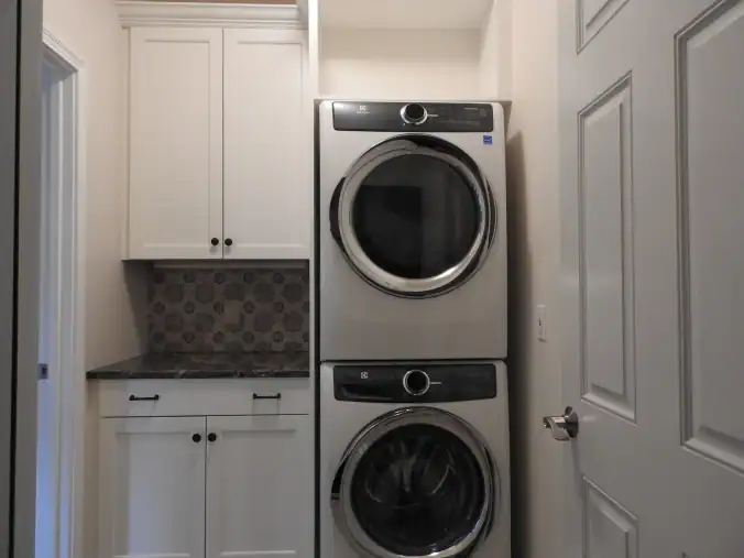 Laundry room w stacking washer and dryer