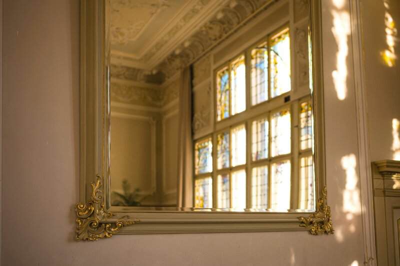 A large mirror hanging on the wall above a sink