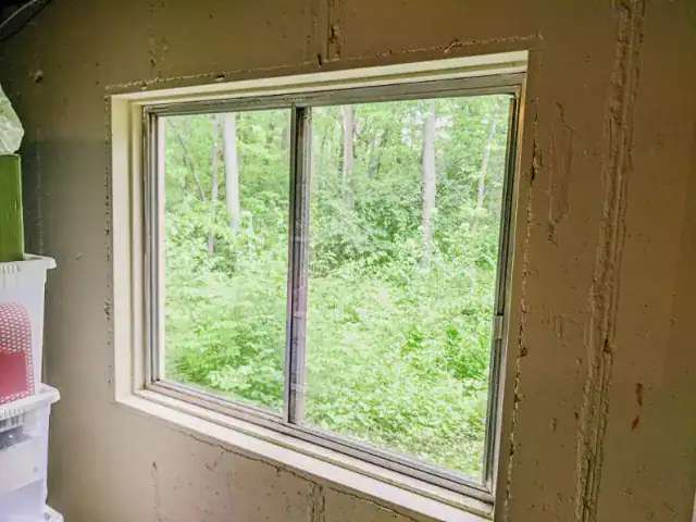 Basement renovation finishing replacing windows single pane window casement sliding energy efficient diy pvc trim broken door picture window egress before.jpg